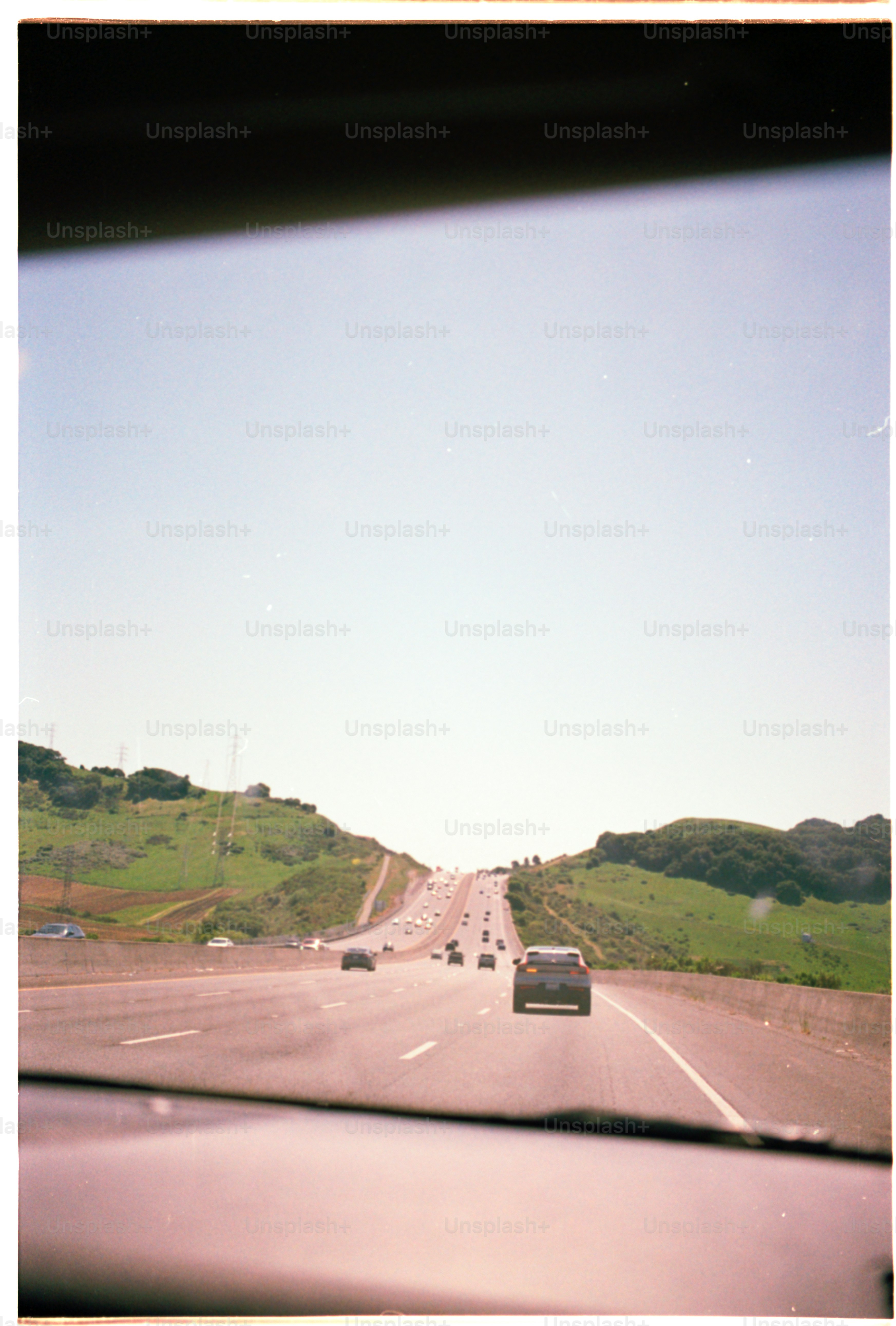 Highway view from a car on a sunny day.